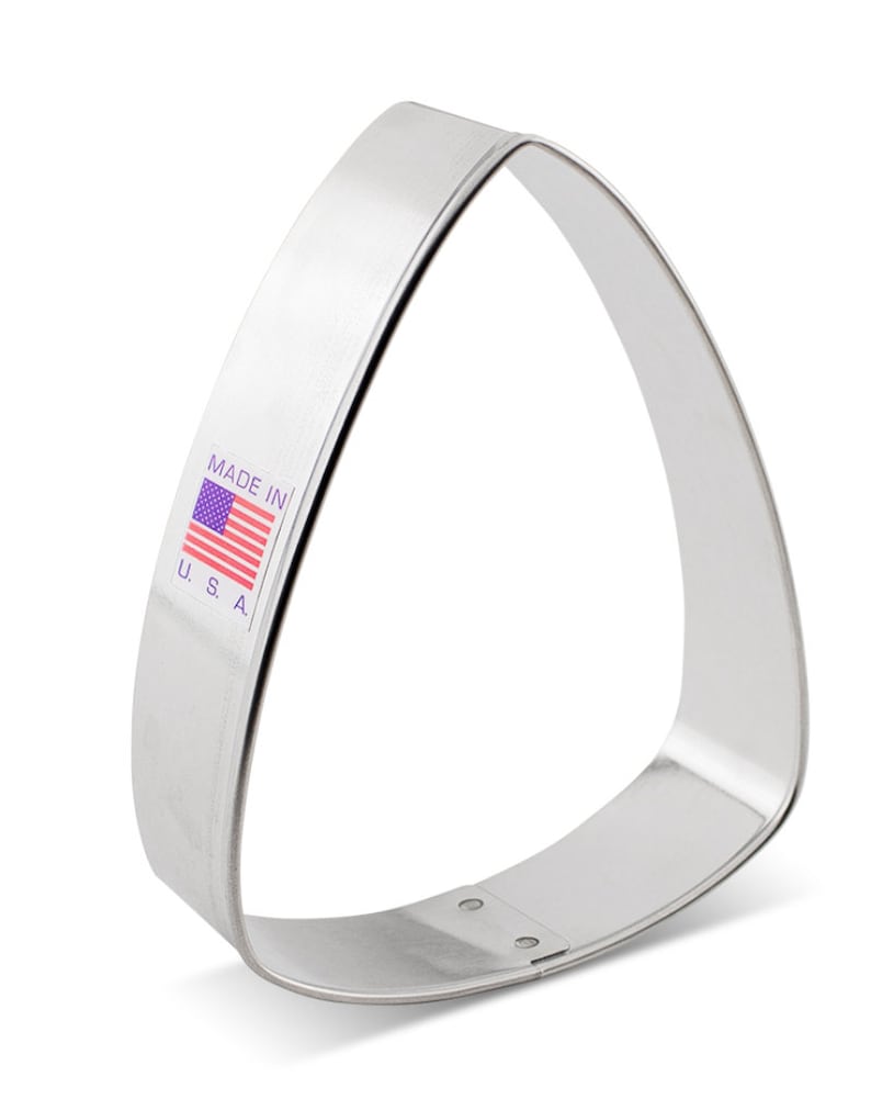 May include: A silver triangle-shaped cookie cutter with a "Made in U.S.A." label.