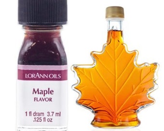 May include: Two bottles of maple flavoring. The bottle on the left is a small, clear glass bottle with a black cap. The bottle on the right is a clear glass bottle shaped like a maple leaf. Both bottles contain a dark amber liquid. The bottle on the left has a label that reads "Lorann Oils Maple Flavor 1 fl dram 3.7 ml .125 fl oz".