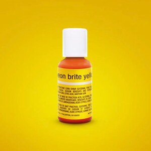 May include: A small bottle of neon yellow food coloring with a white cap. The label reads "eon brite yellow".