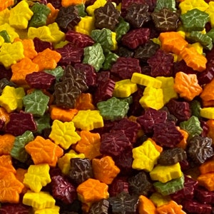 May include: A mix of fall-colored leaf sprinkles in yellow, orange, green, brown, and burgundy.