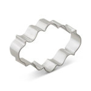 May include: A silver metal cookie cutter shaped like a scalloped oval. The cutter is designed to create decorative cookies or pastries.