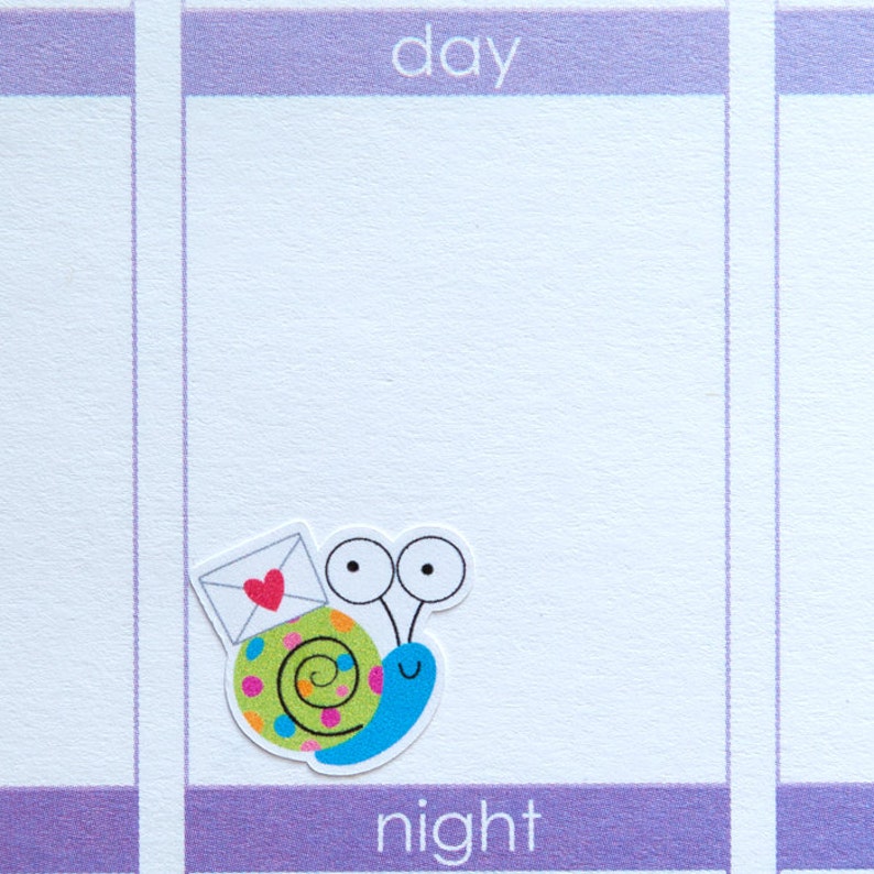 May include: A colorful snail sticker with a red heart on a white envelope, with the words "day" and "night" on a purple background.