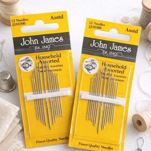 May include: Two yellow and black John James needle packages. Each package reads "12 Needles JJ10300 Assorted" and "Household Assorted". The packages contain multiple needles. The text "Finest Quality Needles" is printed at the bottom of each package.