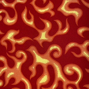 May include: Red fabric with a repeating pattern of yellow and orange flame-like shapes.