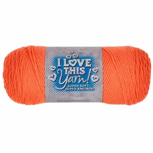 May include: A skein of bright orange yarn with a label that reads "I LOVE THIS YARN!" in blue and white. The label also states "SUPER SOFT! SUPER SAVINGS!" and includes heart-shaped graphics. The yarn is a solid, vibrant color.