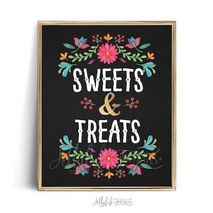 May include: A black chalkboard sign with a gold frame and floral border. The sign says "SWEETS & TREATS" in white text with a gold ampersand.