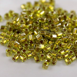 approx. 26g - 1.5mm Cube - TOHO Seed Beads - GOLD LINED Light Olivine - Square seed beads ~ 26 gram tube