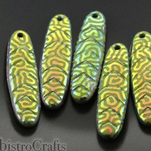 May include: Five iridescent green glass beads with a swirling pattern. The beads are oval shaped and have a hole at the top for stringing.