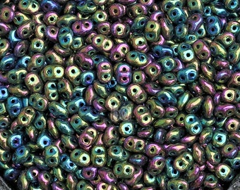 May include: A heart-shaped container filled with iridescent seed beads in shades of green, blue, and purple.