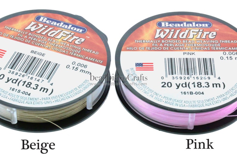 May include: Two spools of Beadalon WildFire thermally bonded bead weaving thread. The spool on the left is beige and the spool on the right is pink. Each spool has a label with the brand name, product name, and product details, including the thread size, length, and color. The label also includes a barcode and the words "Made in USA".