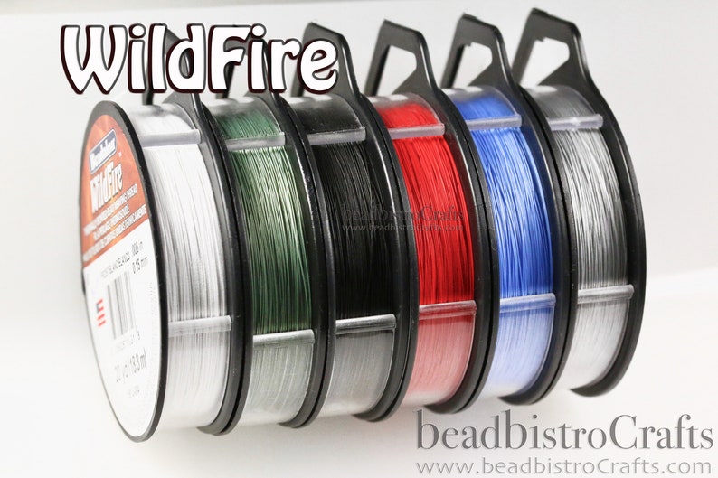 May include: Six spools of WildFire beading wire in various colors, including white, green, black, red, blue, and silver. Each spool is labeled "WildFire" and has a clear plastic container with a black handle.