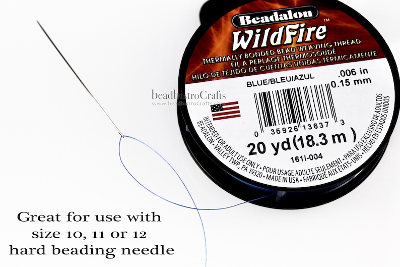 May include: A spool of blue Beadalon WildFire thermally bonded bead weaving thread. The spool is labeled with the text "Beadalon WildFire" and "Blue/Bleu/Azul". The spool is 20 yards (18.3 meters) long and has a 0.006 inch (0.15 mm) diameter. The image also shows a beading needle and thread.