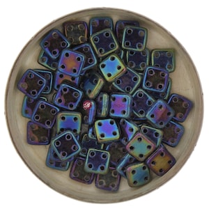 May include: A bowl filled with iridescent black square beads with four holes each. The beads have a metallic sheen and are arranged in a random pattern.