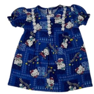 May include: Blue dress featuring a pattern of Hello Kitty characters, hearts, and numbers. The dress has short, puffed sleeves and white lace trim along the neckline. The fabric has a textured appearance.