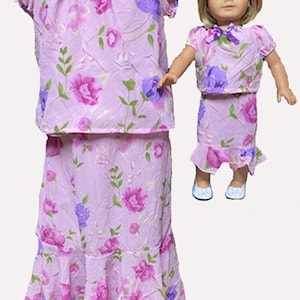 May include: A matching outfit set featuring a lilac floral print. The set includes a top and a tiered skirt. A doll is wearing a matching outfit. The outfits have pink, purple, and green floral patterns.