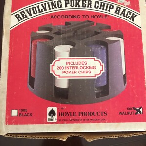 May include: A red box with a revolving poker chip rack. The box says "Revolving Poker Chip Rack" and "According to Hoyle". It includes 200 interlocking poker chips. The box is made by Hoyle Products and is made in the USA.