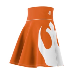 May include: An orange skirt with a white Rebel Alliance symbol. The skirt has a high waist and a flared silhouette.