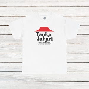 May include: White t-shirt with a red and black logo that says "Tanka Jahari" and the text "I would never order a whole pizza for myself".