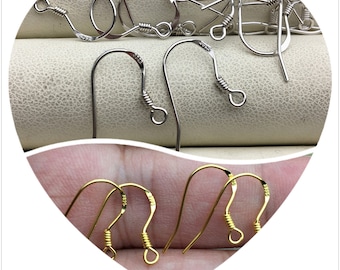 May include: A close-up of two sets of earring hooks. One set is silver and the other is gold. The hooks are made of metal and have a spring closure.