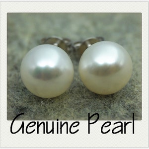 May include: A pair of white pearl stud earrings with silver posts. The pearls are round and smooth, and they are set in a simple design.