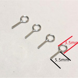 May include: Three silver jump rings with a straight pin attached. The rings are approximately 3.5 mm in diameter and the pins are 5.5 mm long.