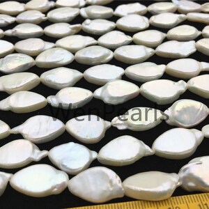 May include: A strand of white baroque freshwater pearls, each pearl is a unique, irregular shape. The pearls are arranged in a staggered pattern, creating a visually appealing design. The pearls are approximately 10-12mm in size.