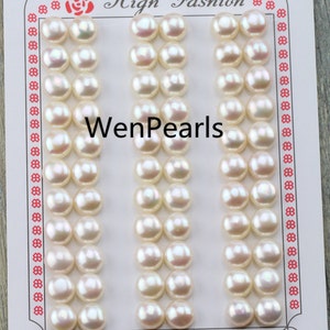 May include: A card with rows of lustrous, off-white pearls. The card has a decorative border and the words "High Fashion" and "WenPearls" printed on it. The pearls are arranged in neat columns, showcasing their smooth, round shape.
