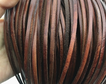 May include: A close-up of a bundle of brown leather cord. The cord is smooth and supple, and it is perfect for crafting projects.