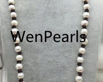 May include: A white pearl necklace with brown leather cord. The necklace is on a white mannequin. The text "WenPearls" is visible on the mannequin.