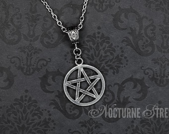 May include: A silver chain necklace with a silver pentagram pendant. The pendant is a five-pointed star inside a circle.