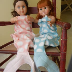 Image of dolls wearing  mermaid tails:   pink/white polka dot  with pink tail and  blue/white polka dot  with pale blue tail