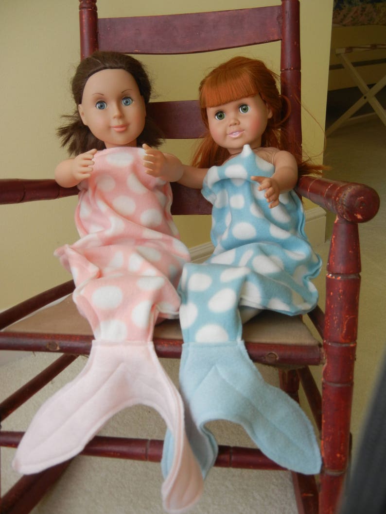 Image of dolls wearing  mermaid tails:   pink/white polka dot  with pink tail and  blue/white polka dot  with pale blue tail