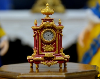 French dolls' house, scale 1/12, Cartel, Pendulum, Louis XVI Clock, gold ornamentation on a brick red background.