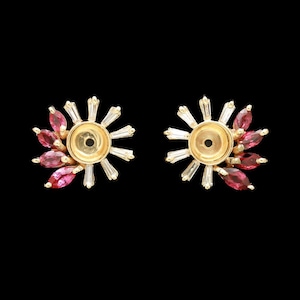 May include: A pair of gold stud earrings featuring a central circular setting surrounded by a sunburst arrangement of alternating marquise-cut pink gemstones and clear baguette-cut stones, creating a radiant and symmetrical floral-like design.