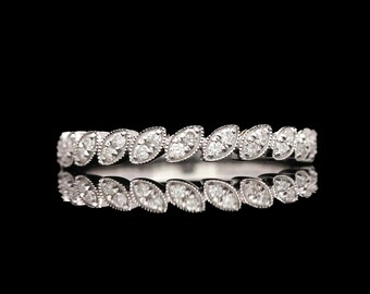 May include: A silver band ring with a row of marquise-shaped diamonds set in a leaf pattern.