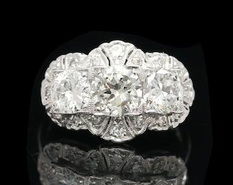Late Edwardian Platinum Three Stone 2.10 ctw Diamond Halo Ring
