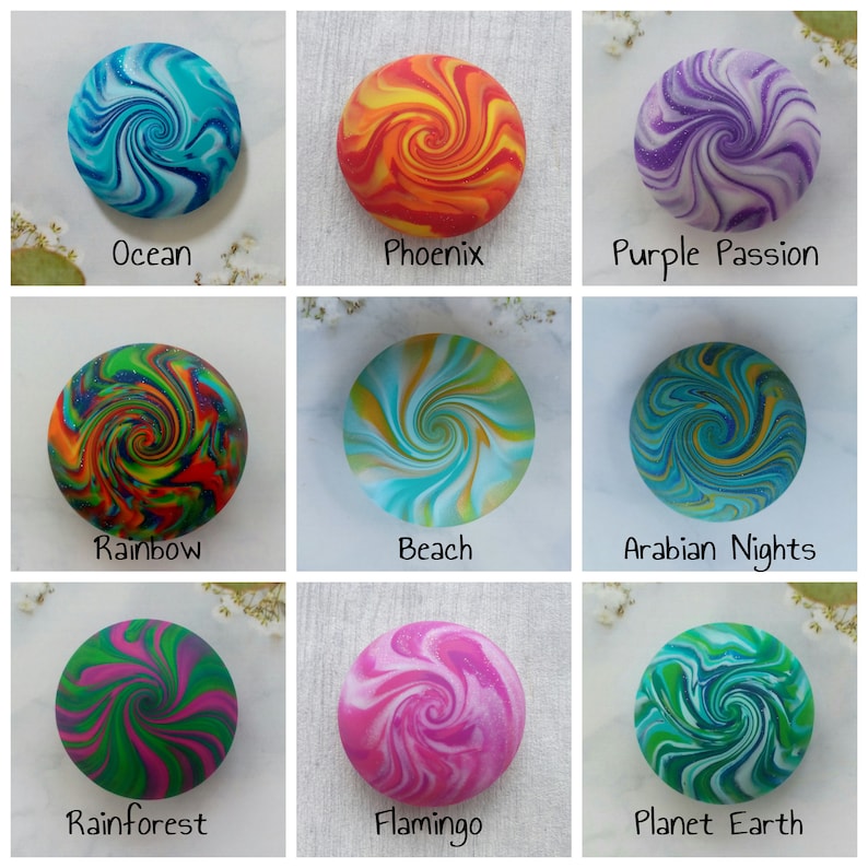 May include: A grid of nine circular objects with swirling patterns. The labels are Ocean in blue, Phoenix in orange, Purple Passion in purple, Rainbow in multi-color, Beach in teal, Arabian Nights in dark blue, Rainforest in green, Flamingo in pink, and Planet Earth in green.