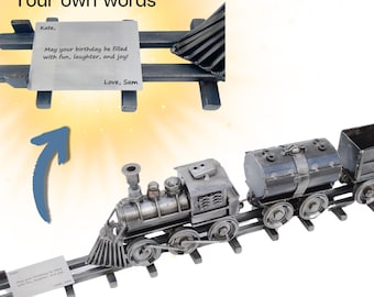 May include: A metal train engine and boxcars with a small card that says "Kate, May your birthday be filled with fun, laughter, and joy! Love, Sam".