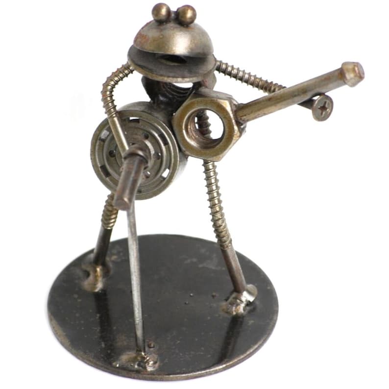 May include: A whimsical sculpture of a musician crafted from metal hardware. The figure, with a round head and body, appears to be playing a guitar. The sculpture is mounted on a circular base, showcasing a unique blend of industrial and artistic design.