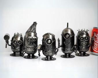 May include: Five metal sculptures of Minions, each with a unique design and personality. The Minions are made from recycled metal and have a black finish.