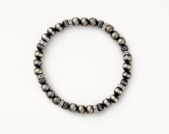 May include: A silver bracelet with small round beads and clear crystal accents.