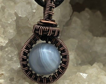 Copper wire wrapped blue laced agate pendant.