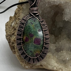 Antiqued copper wire wrapped Ruby fushite pendant
