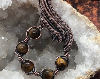 Antiqued copper wire wrapped pendant with tiger eye accent beads
