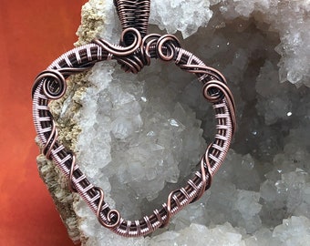 Antiqued copper and pink coated wire wrapped heart pendant