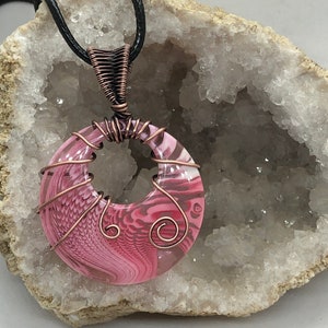 Pink swirled resin pendant wrapped in copper wire
