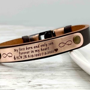May include: Brown leather bracelet with a rose gold metal plate engraved with the text "My first born and only son Forever in my heart PLW JR 6.19.1993-7.9.2021" and infinity symbols with the word "love" and a heart.