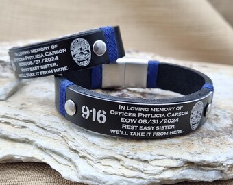 May include: Two black leather bracelets with blue thread accents and silver-tone metal hardware. The bracelets are engraved with the text: IN LOVING MEMORY OF OFFICER PHYLICIA CARSON EOW 08/31/2024 REST EASY SISTER, WE'LL TAKE IT FROM HERE and 916.