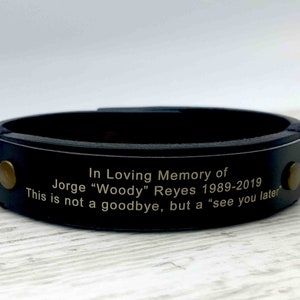 May include: Black leather bracelet with a gold metal plate engraved with the text "In Loving Memory of Jorge "Woody" Reyes 1989-2019 This is not a goodbye, but a "see you later"