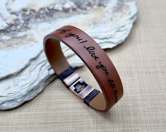 May include: Brown leather bracelet with a copper clasp. The bracelet is engraved with the text "I love you so much!"